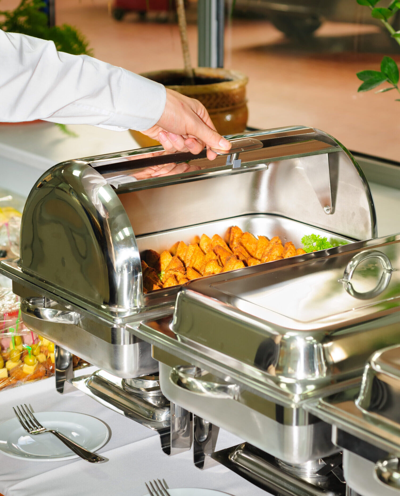 chafing dish heater filled with ready grilled meat inside